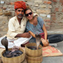 Tourist posing for photo with an Indian cobra enchanter Volunteer abroad opportunities for grown-ups