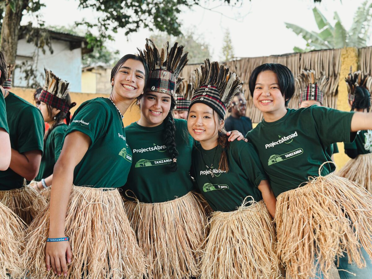 Tanzania - Drumming and dancing Project Abroad volunteers in Tanzanian outfits